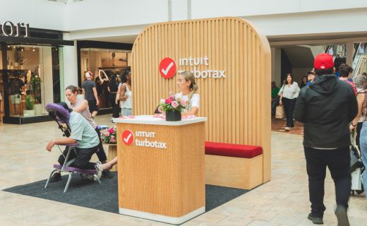 turbo tax wooden pop up with people walking by 