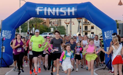 group of people starting to run with the finish line in the background