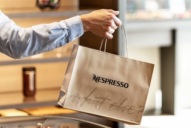 man holding nespresso shopping bag