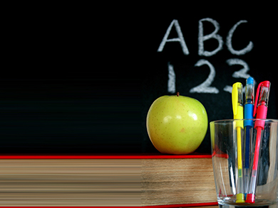 Chalkboard with ABC 123 an apple and a cup of pens