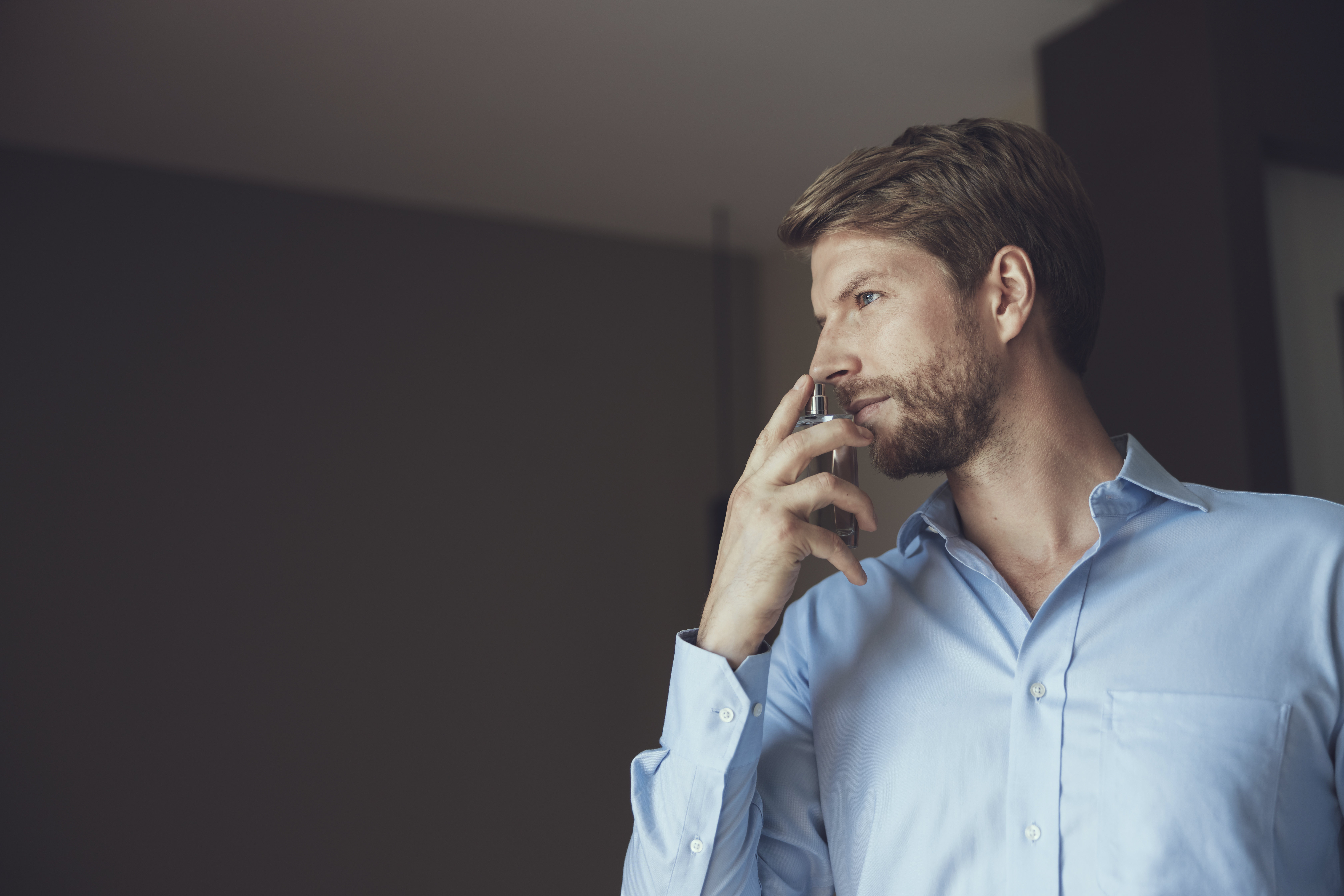 Man looking to the side in a blue shirt 