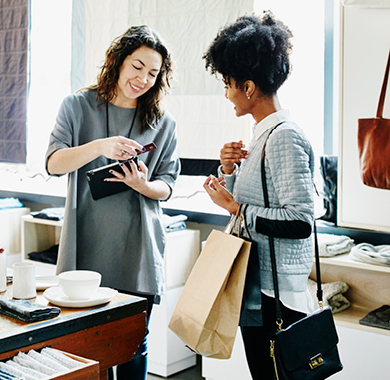 Two women in business transaction.