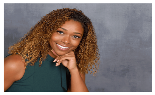 Girl wearing a green dress with bow posing for her business headshot photo. 