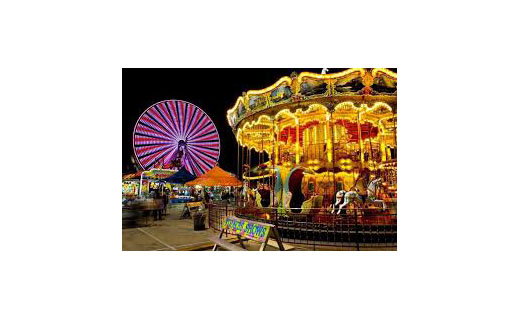 Carnival rides such as a carousel and ferris wheel and games and concession stands