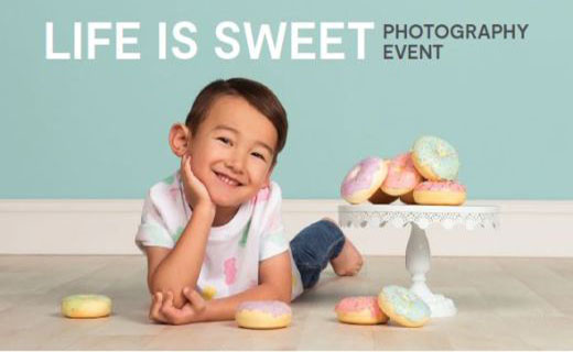 Boy smiling and laying on gray floor with donuts. Teal background with the words Life is Sweet Photography Event.