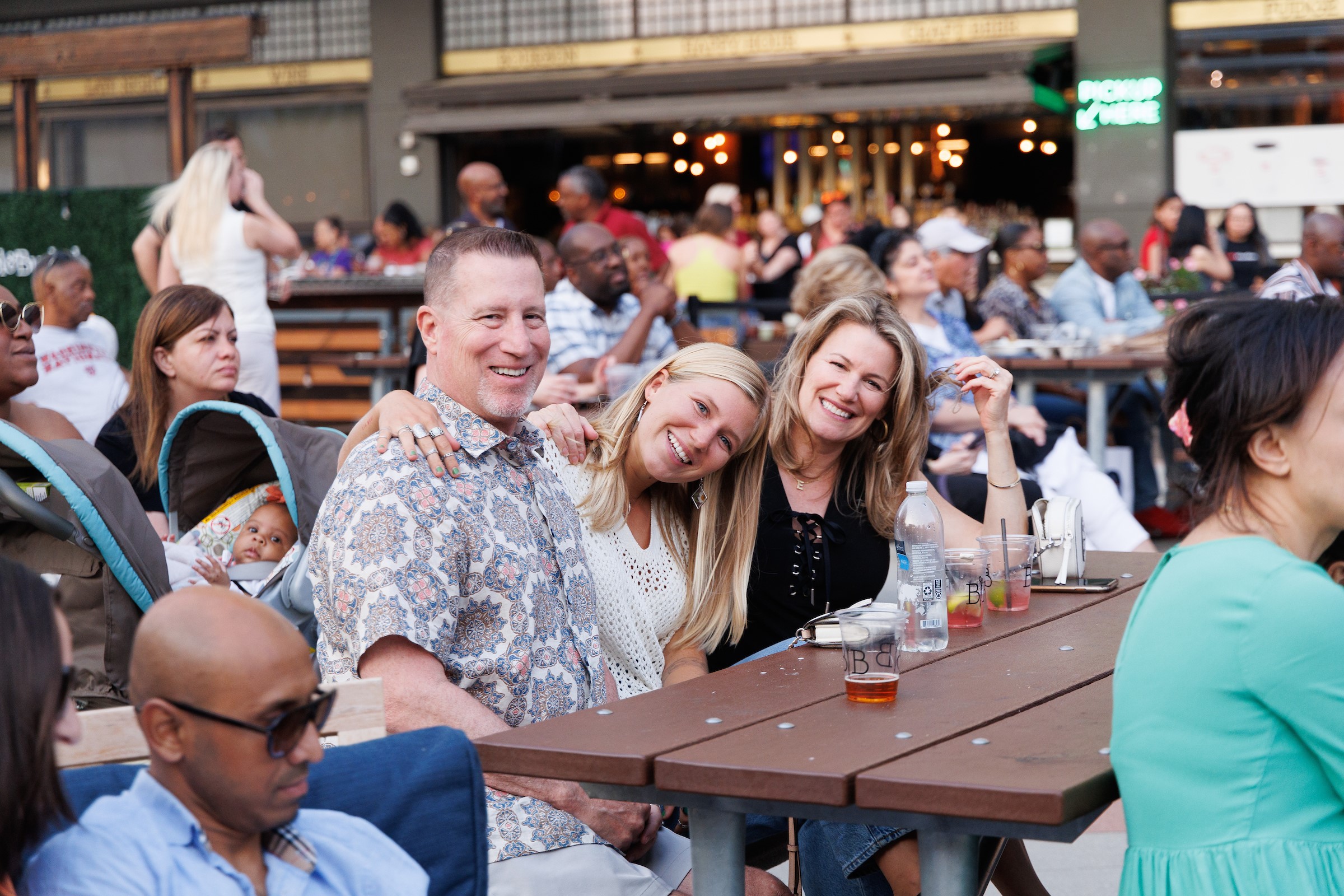 group on penfed plaza smiling at a picnic table