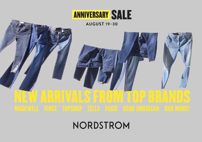 Image of jeans hung on a clothing line over a gray background