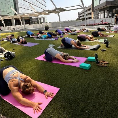 group doing yoga stretch 