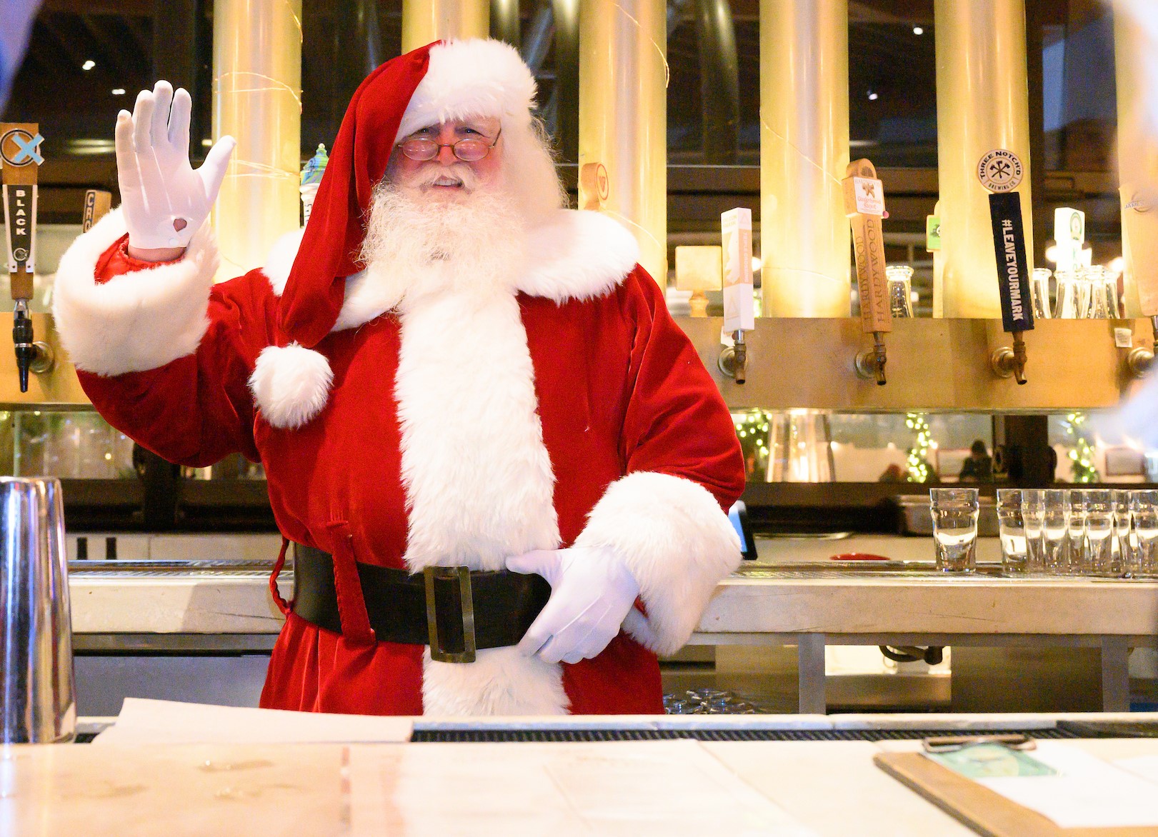 Santa standing behind a restaurant bar 