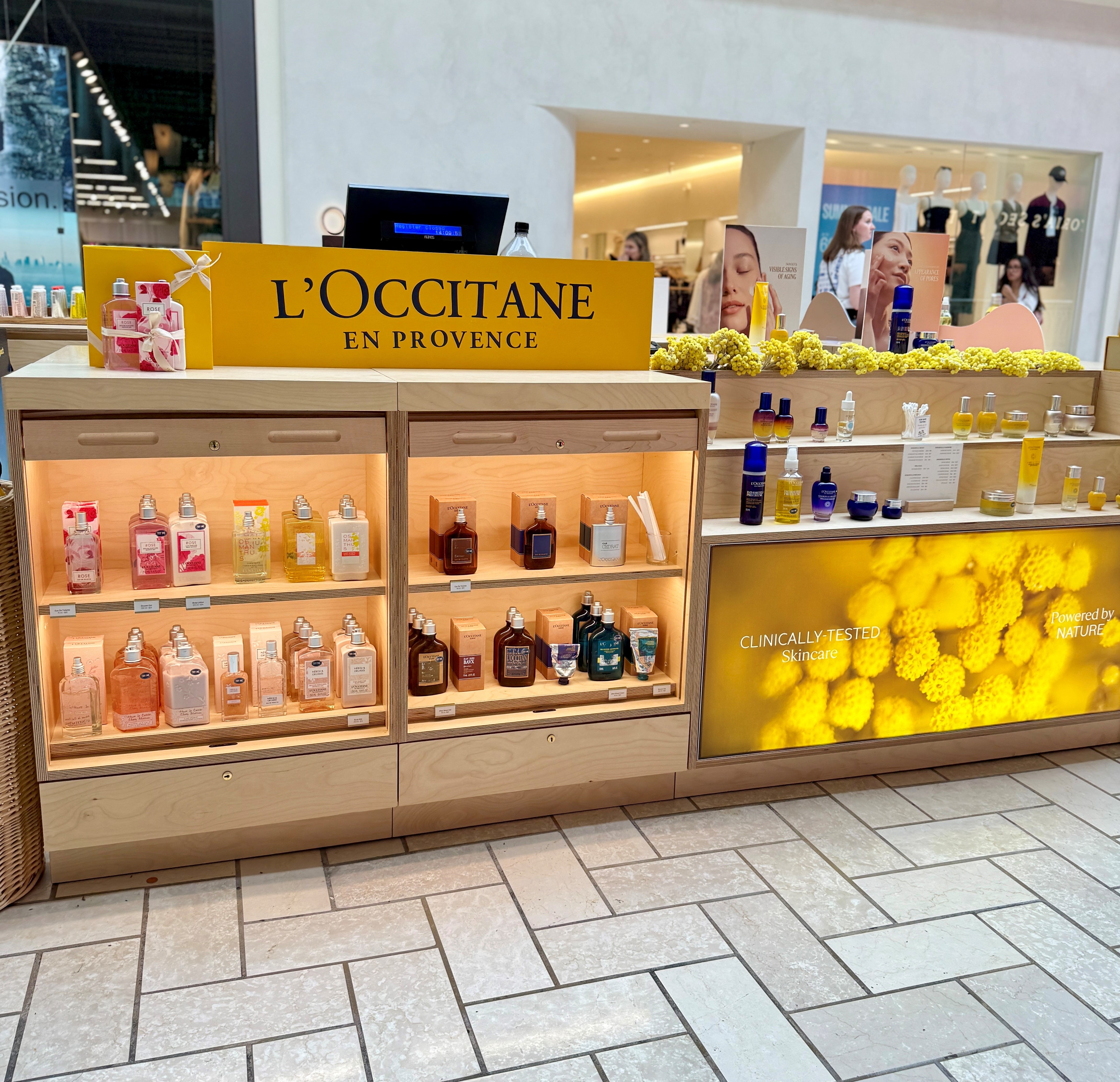 temporary retail kiosk stocked and merchandised with L'Occitane products