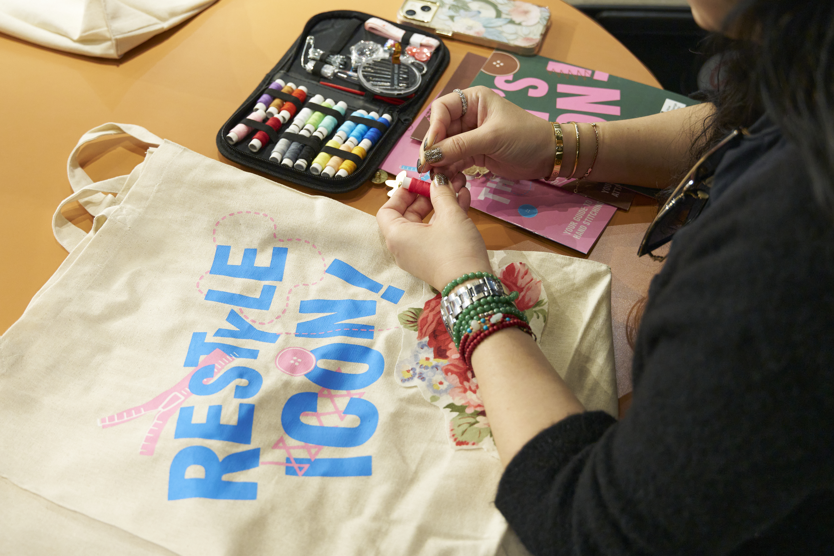 hands working to repair a garment