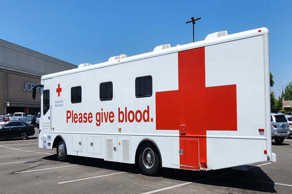 The American Red Cross Blood Mobile parked outside of JCPenney in the parking lot.