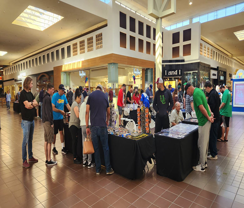 Shoppers inside of a mall looking at sports memorabilia items.