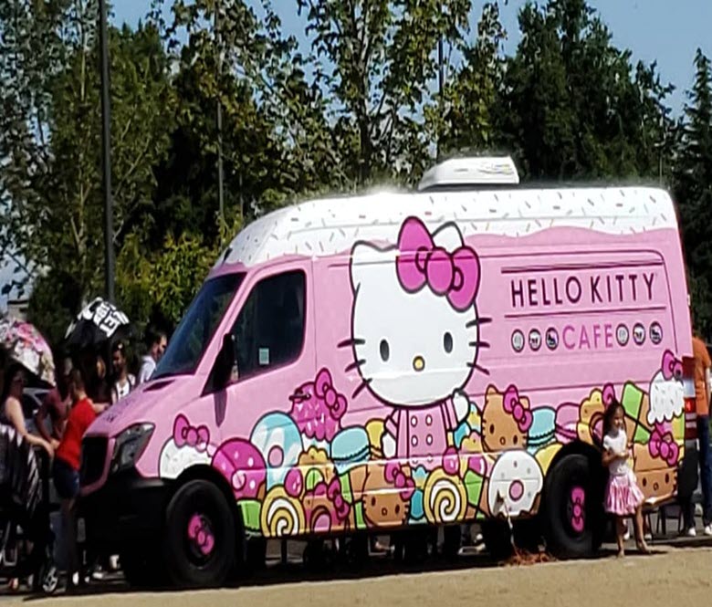 A Hello Kitty Café mobile outside with people waiting to purchase merchandise.