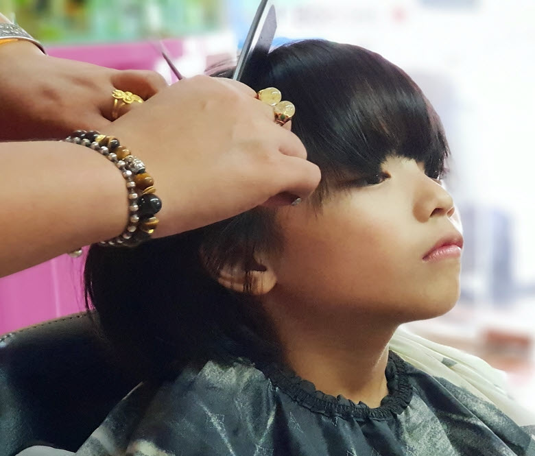 A child getting their hair cut.