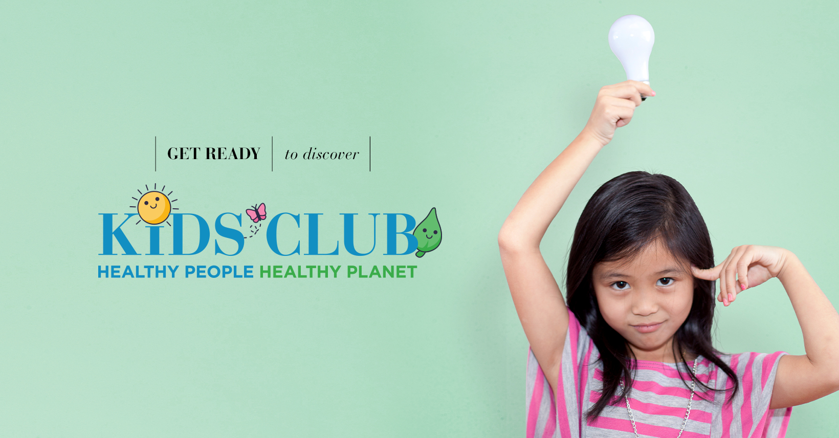 young girl holding a light bulb over her head