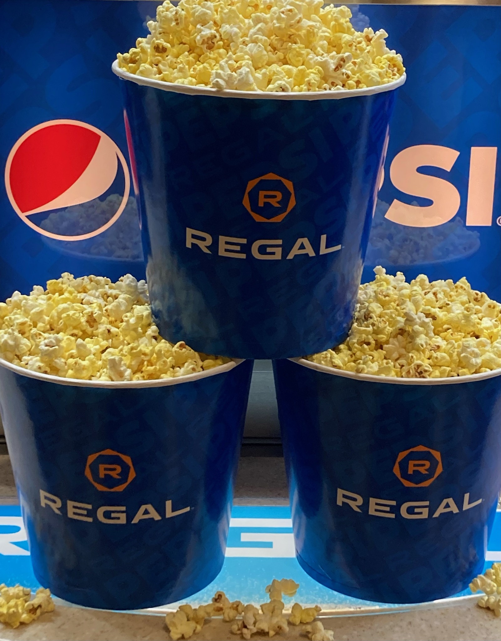 Three round boxes of popcorn.