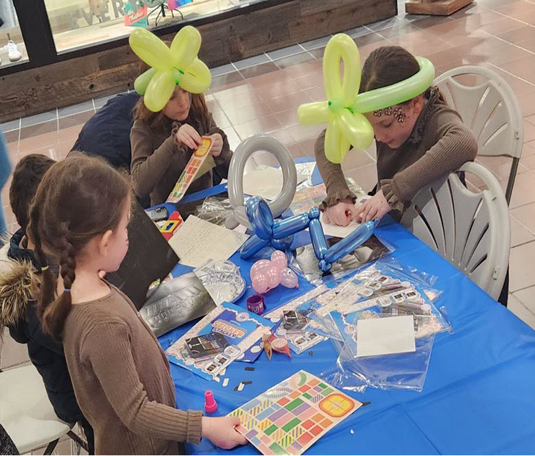 Kids doing crafts at a table.