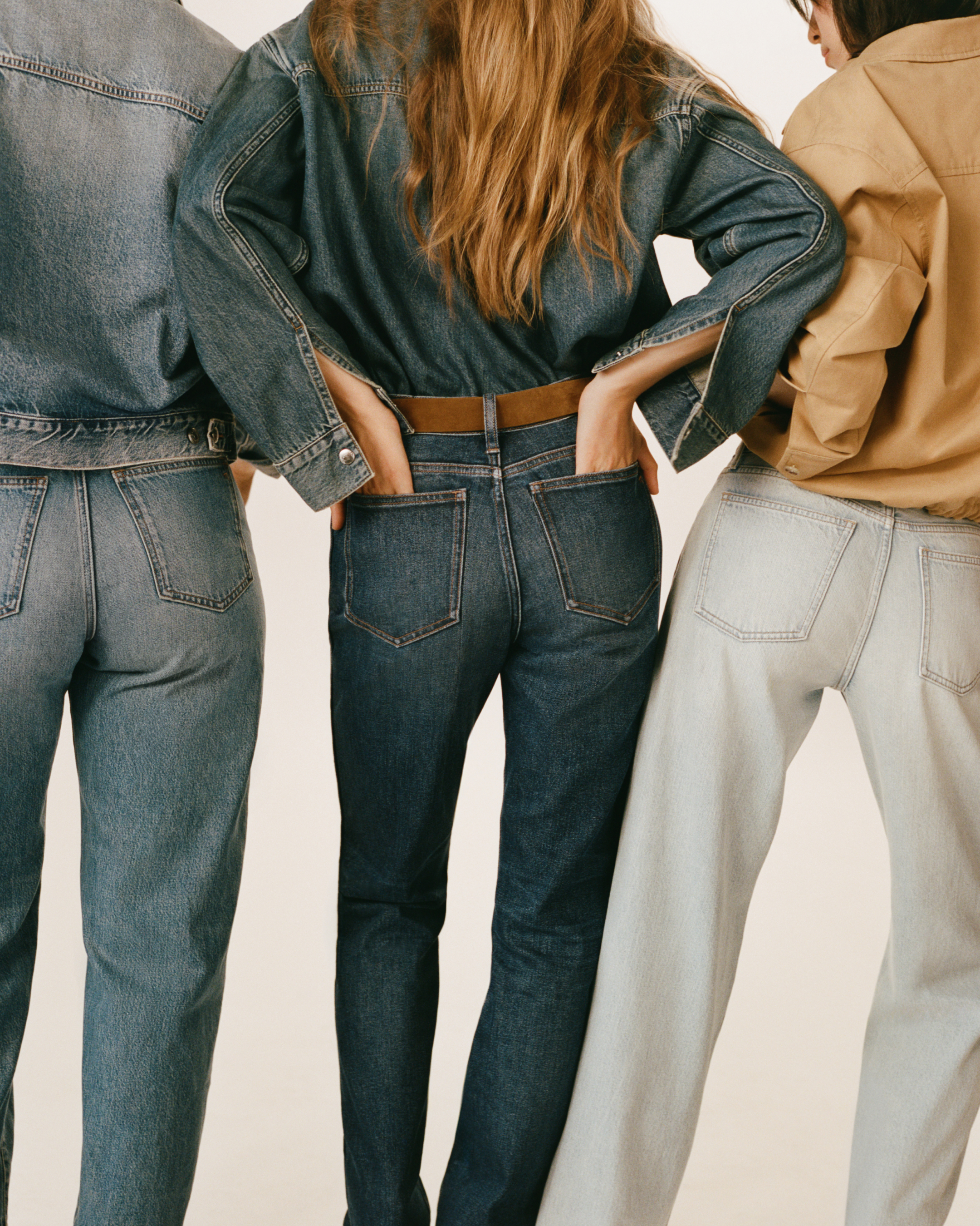 A group of women facing their backs with the their hands in their pocket