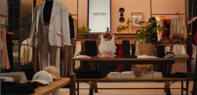 The interior of the Aritzia store, showing a table stacked with folded merchandise