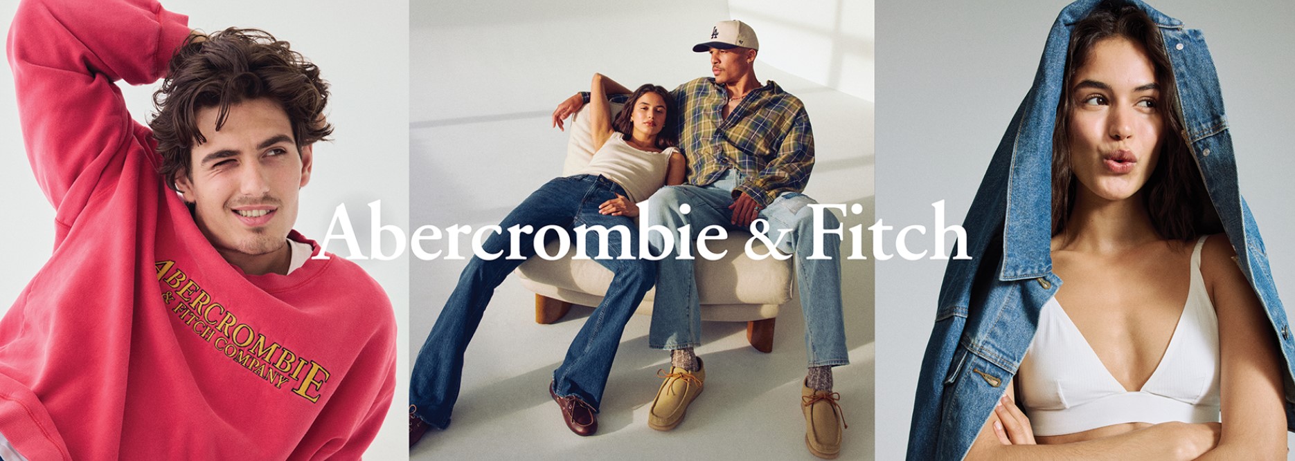 A young man is wearing a red sweatshirt that says Abercrombie, two young adults slouging in jeans and a plaid shirty and a young adult girl wearing a white sports bra with a denim jacket on her head