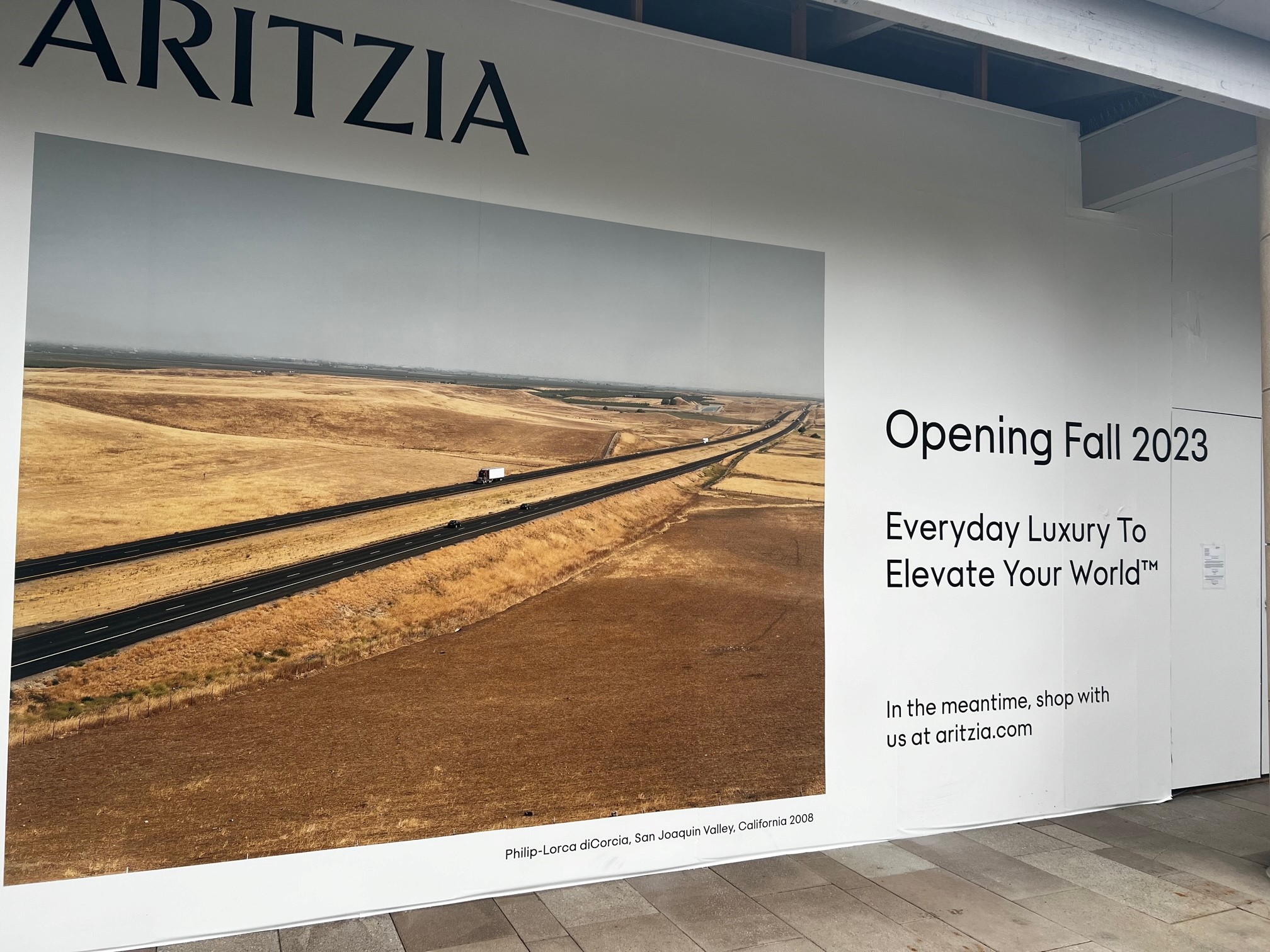 Aritzia barricade announcing their opening this fall