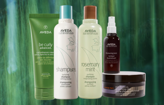 Aveda hair products against a green backdrop