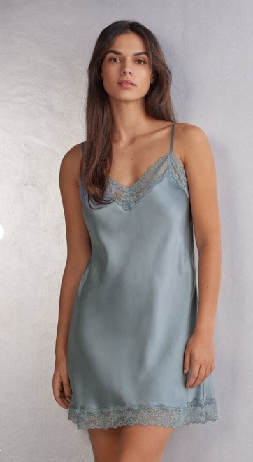 A woman wearing a slate blue slip from Intimissimi