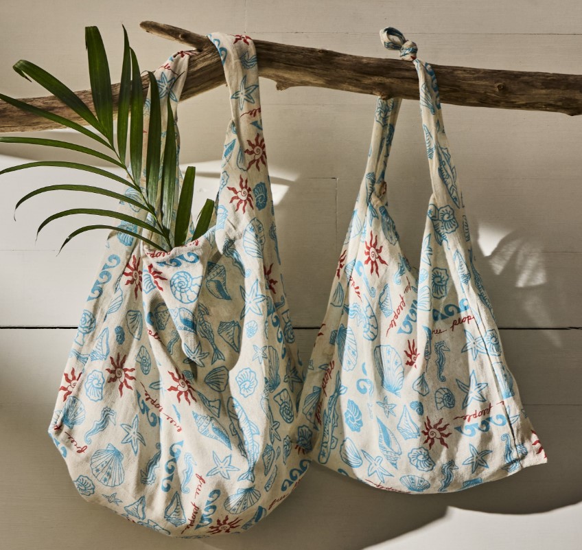 Two colorful bags with seashells on them