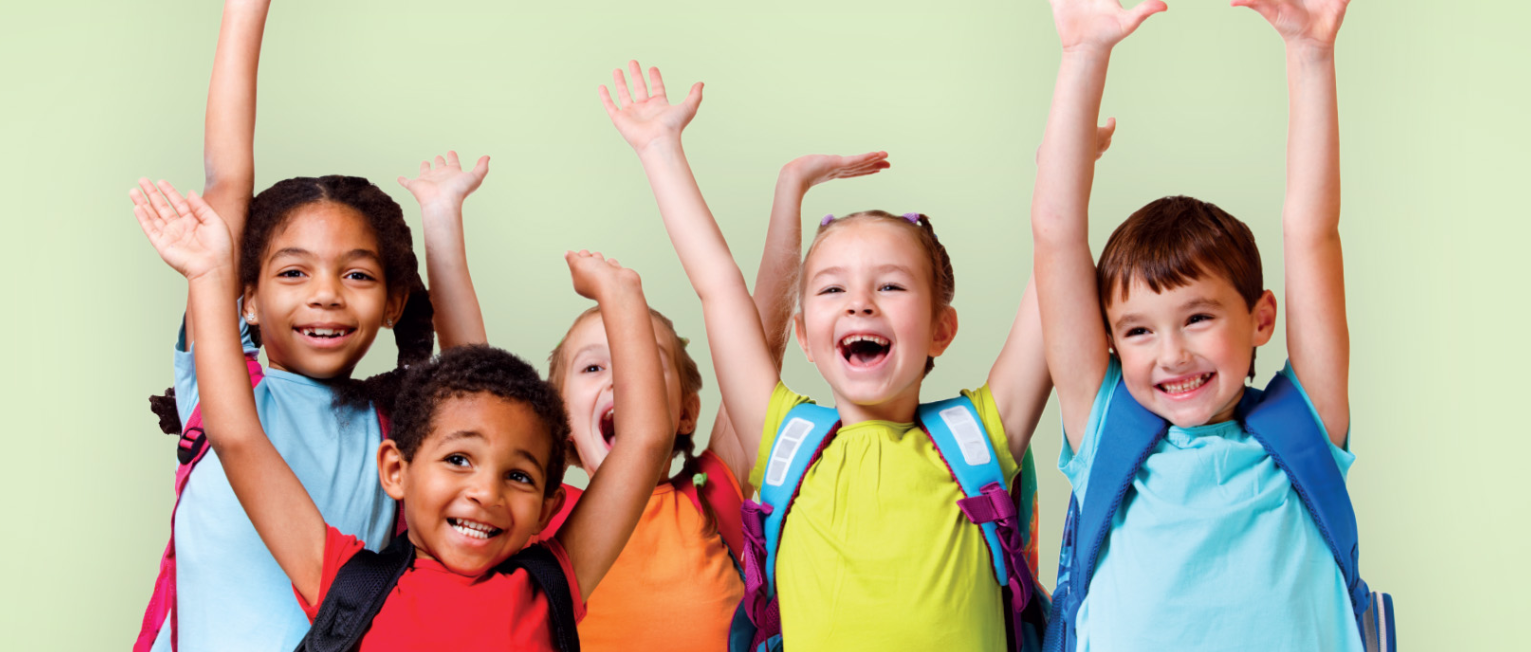 
A group of kids outfitted in backpacks with their hands in the air
