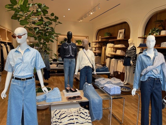 Mannequins in denim and blue shirts in the interior of the new J. Crew store