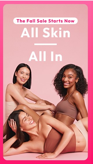 Three women wearing beige tops and bottoms, sitting on the floor against a pink background 