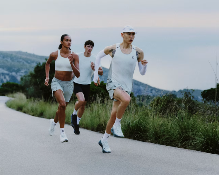 Three people running along a path