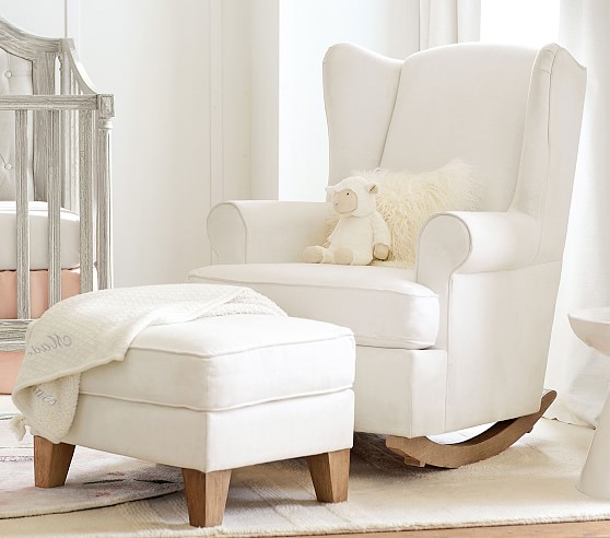A white nursery glider from Pottery Barn Kids in a white room