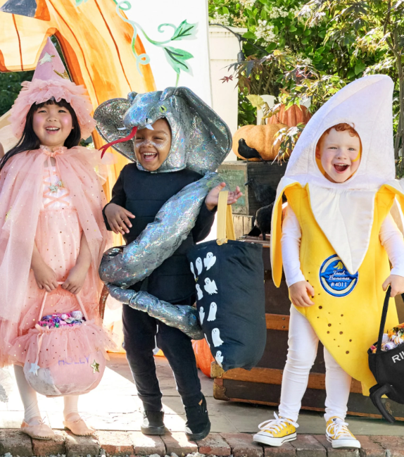 Three kids in Halloween costumes