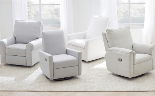 A group of white nursery chairs from Pottery Barn Kids in a white room