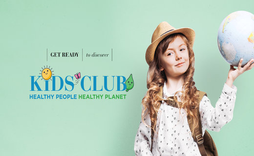 Young girl holding a globe promoting virtual kids club