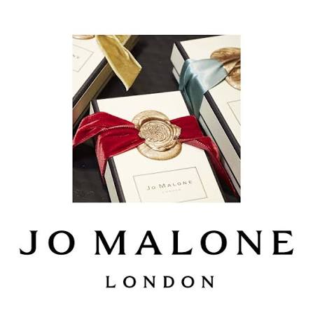 A Jo Malone gift box with a wax seal adorned red ribbon