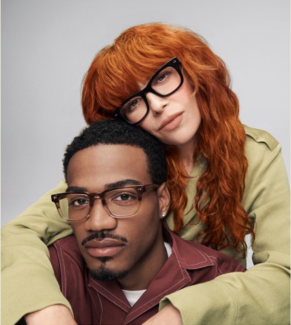 A young woman with her arms around a young guy, wearing glasses from Warby Parker