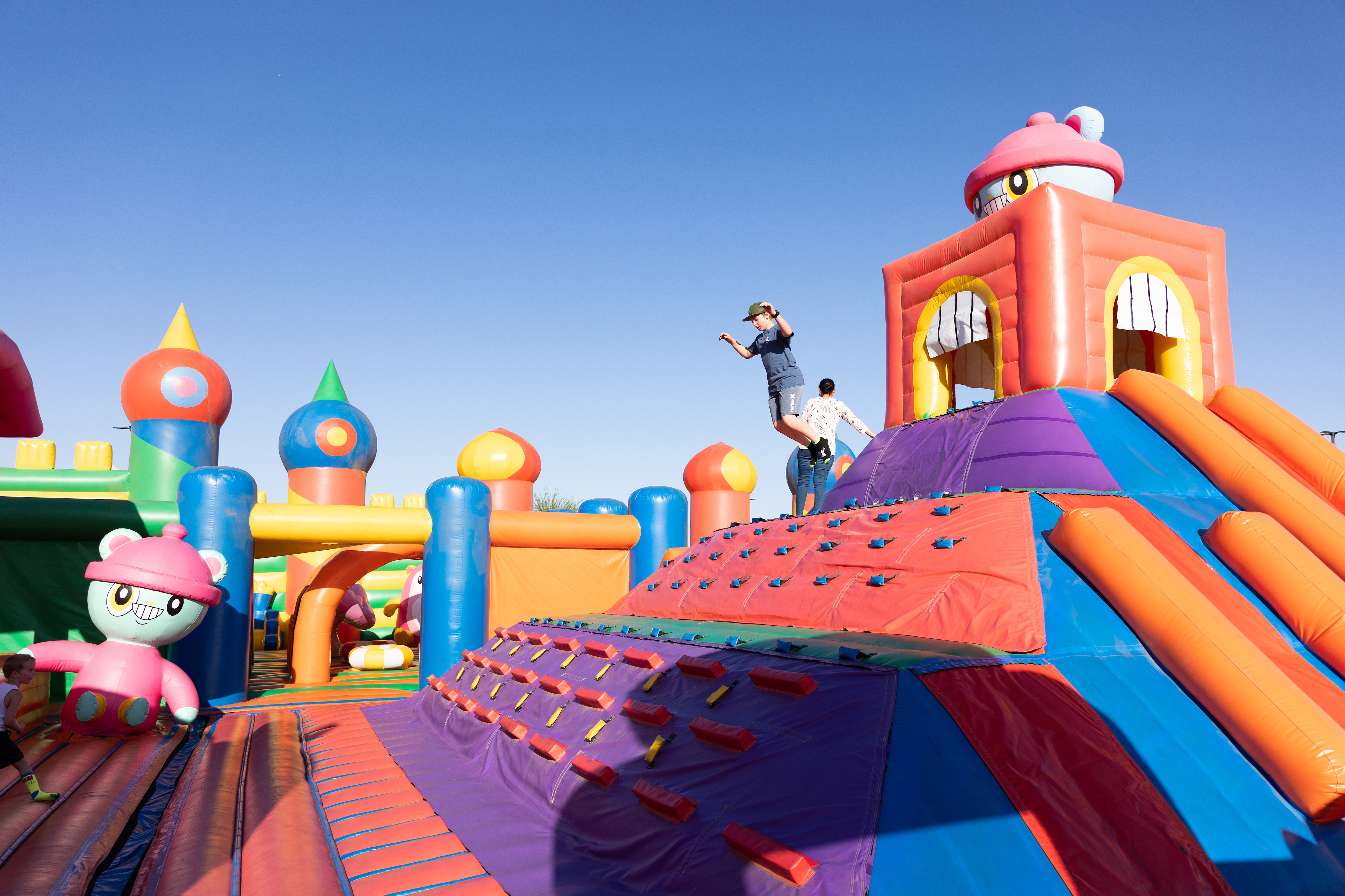 children bouncing on giant bounce house