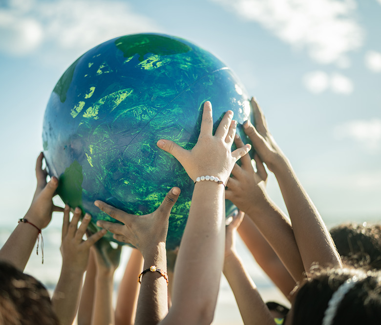 kids holding a globe together