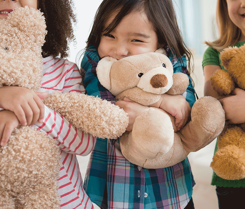 kids hugging teddy bears