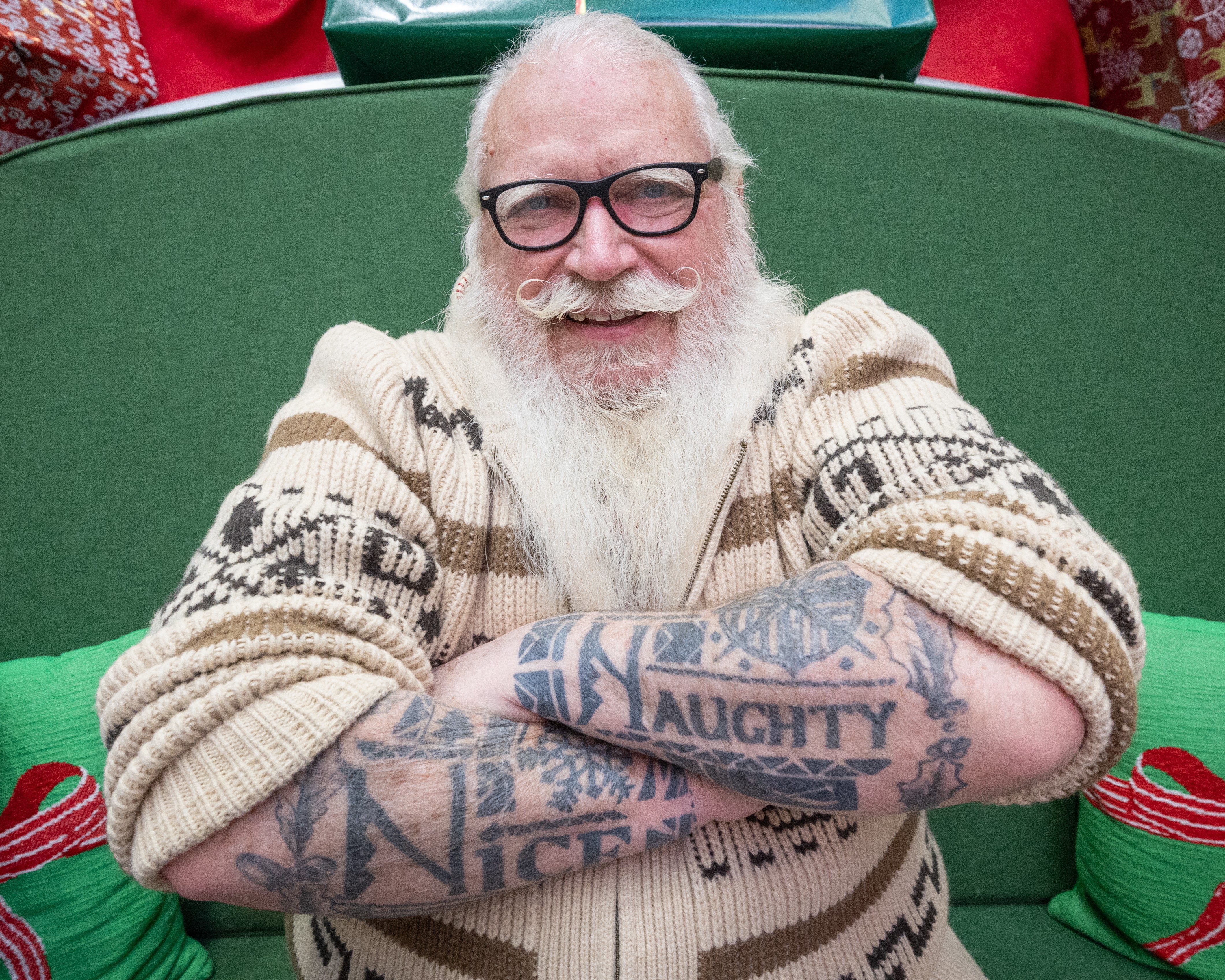Santa with tattoos that say Naughty and Nice