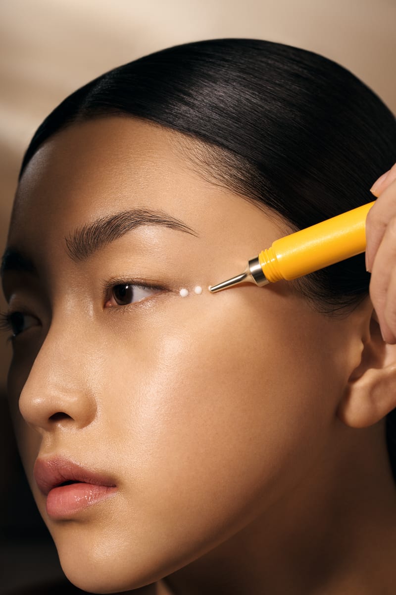 Closeup of woman applying skincare product to her face