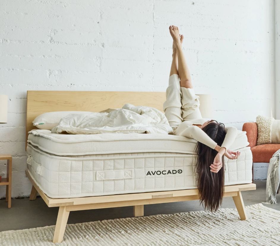 a woman stretching on an Avocado mattress