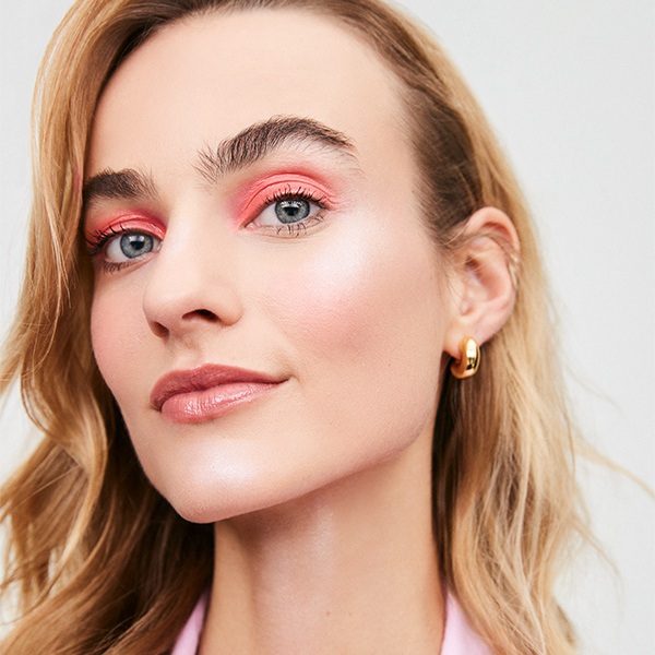 A Woman with pink red and coral makeup