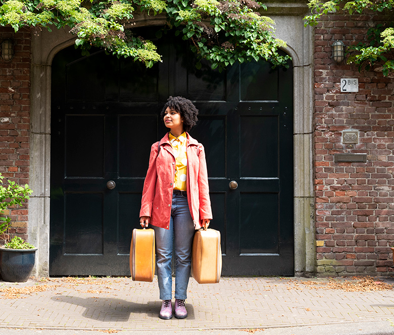 Person holding two suitcases
