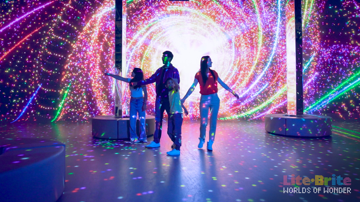 Lite-Brite: Worlds of Wonder, featuring a family enjoying this immersive experience