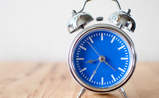 Blue Alarm Clock on a table. 