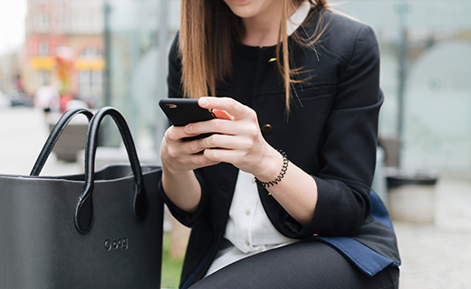 woman sitting down looking at cell phone